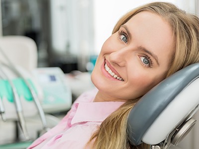 woman in a dental chair smiling