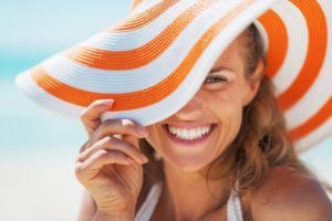 Woman in sun hat smiles after visiting Tysons, VA dentist